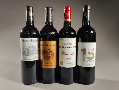 three bottles of red wine are lined up on a table