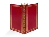 un livre rouge ouvert, bordé d'or, sur fond blanc