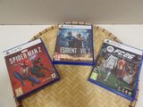 three video games sitting on a tray on a table