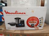 packaging of a food processor sitting on top of a cardboard box