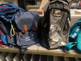 several backpacks are sitting on a shelf in a store