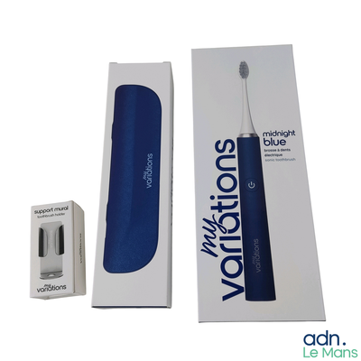 a blue toothbrush in a box next to a box of toothpaste
