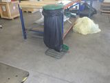 a trash can sitting on a work bench in a garage