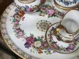 a plate with a tea set on it on a glass table