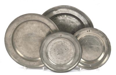 a lot of silver plates sitting on a white surface