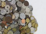 a pile of coins sitting on a white surface
