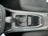 a close up of a car ' s center console and gear lever