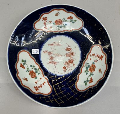 a blue and white plate with orange flowers on it