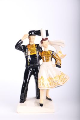a figurine of a man and a woman dressed in military clothing