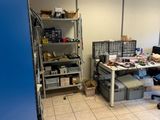 une pièce contenant un bureau, des étagères et une chaise