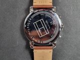 a close up of a watch on a table with a black background