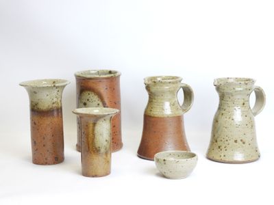 a group of vases that are sitting on a table