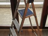 a ladder that is leaning against a window in a room