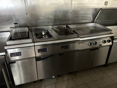 a kitchen with stainless steel appliances and a stove