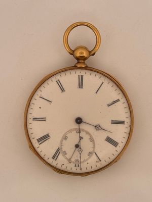 a gold pocket watch with roman numerals on the face