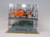 an orange truck and a green truck in a clear case