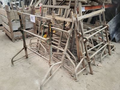 a pile of chairs that are sitting in a warehouse