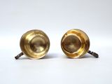 pair of antique brass candlesticks on white background