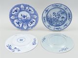 three blue and white plates with designs on them sitting on a table