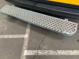 a close up of a metal grate on the side of a bus