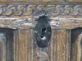 a close up of a wooden door with a keyhole