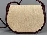 a beige and brown purse with a brown handle