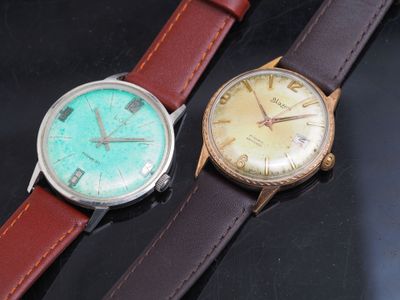 two watches sitting next to each other on a table