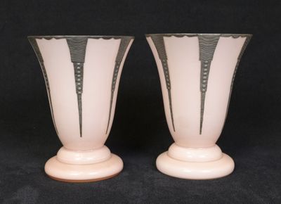 two vases that are sitting on a black surface
