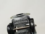 a close up of a metal object on a white surface