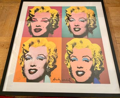 marilyn monroe pop art print in a black frame on a wooden floor
