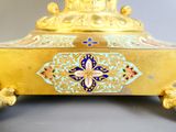 a gold plate with a blue and white design on it