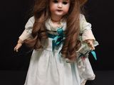 a doll that is wearing a hat and dress