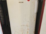 a white refrigerator sitting in the corner of a room