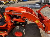 a picture of a kubota tractor parked in a parking lot