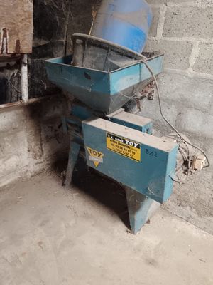 a blue machine that is sitting in the corner of a room