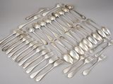 a lot of silver spoons and forks on the table