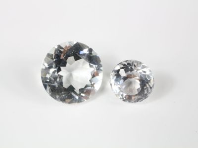un gros plan sur deux diamants posés sur une surface blanche