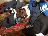 a pile of clothes that is sitting on a couch