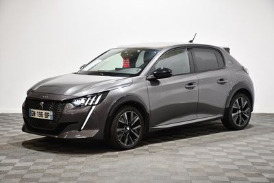 a grey car parked on a checkered floor in a room