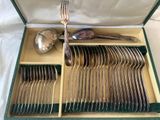silverware in a green box with spoons and spoons in it