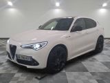 the white alfa suv is parked in a large room