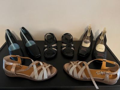 several pairs of shoes are lined up on a black table
