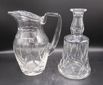 two clear glass vases sitting on a table next to each other