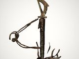 a bronze sculpture of a man holding a golf club on top of a wooden stick