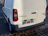 a white van that is parked on the side of the street