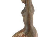 a statue of a woman holding a bowl on top of her head