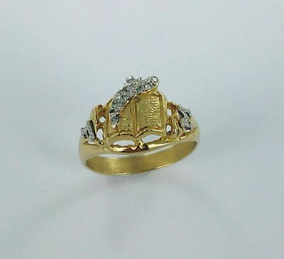 an image of a gold ring with a book on it