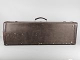 an old brown suitcase sitting on top of a white surface
