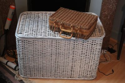a wicker basket with a wicker bag on top of it