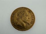 a close up of a gold coin with a man ' s face on it